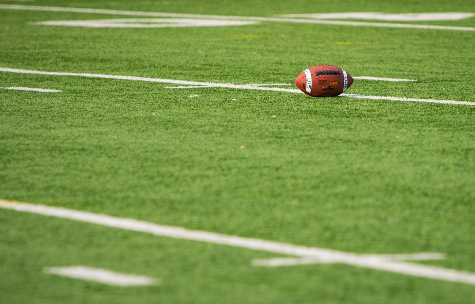 Football on a marked field, representing comparing different dynasty trade calculator tools