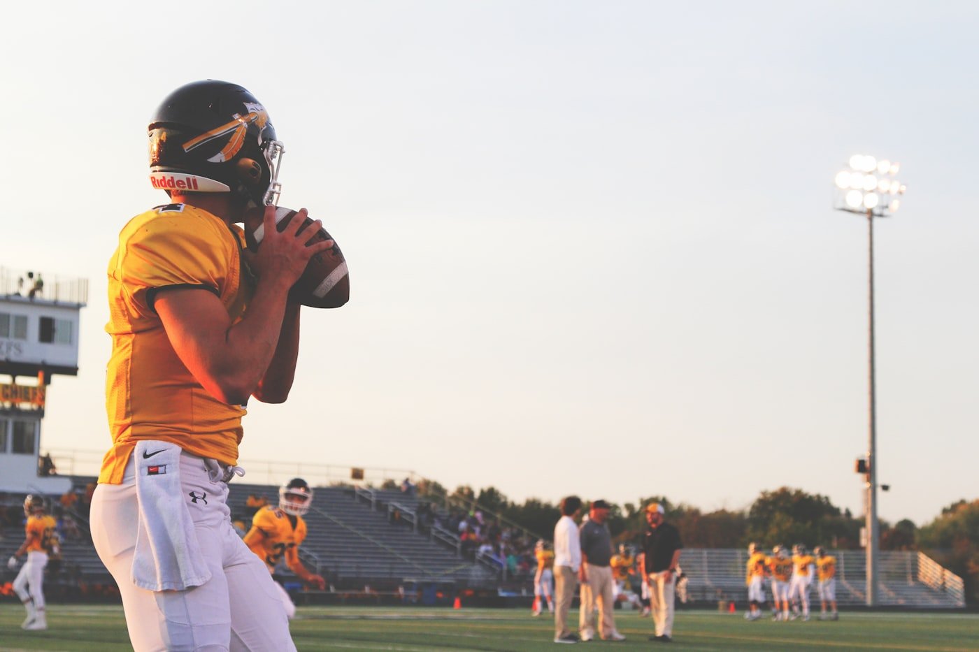 Football player holding a football, representing evaluating a dynasty buy-low or sell-high trade candidate